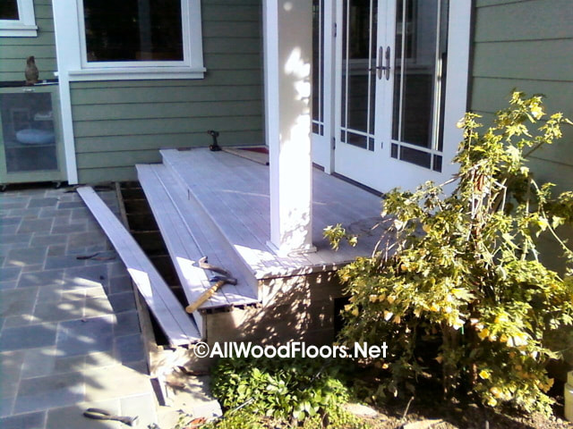 Before Photo of porch replaced by All Wood Floors.